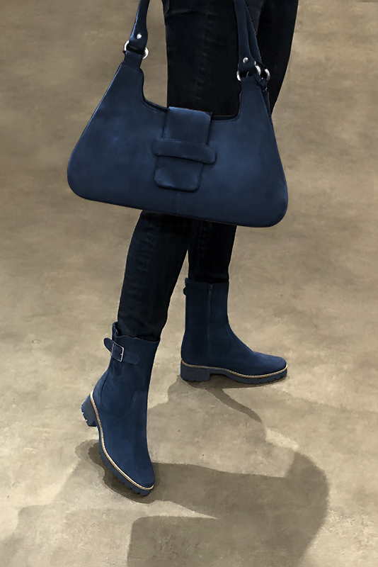Navy blue women's ankle boots with buckles on the sides. Round toe. Low rubber soles. Worn view - Florence KOOIJMAN